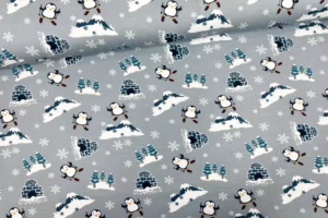 Sweat Weihnachtsstoff Kinderstoff mit Pinguin fährt Ski in hellgrau