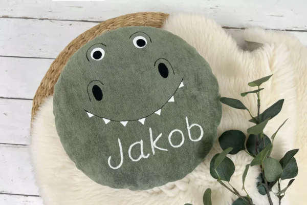 rundes Kissen mit Namen für Kinder mit Dinosaurier Gesicht grün
