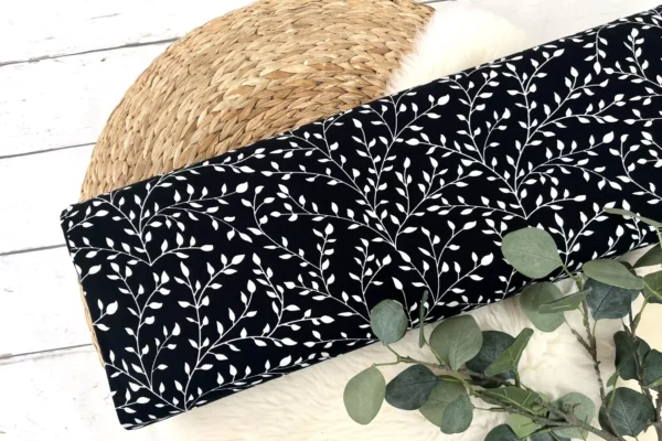 Viskosejersey Stoff mit Blätterranken in schwarz. Ein perfekter Stoff zum nächen von Damenkleider.