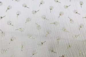 Musselin Stoff mit goldenen Pusteblumen in weiß